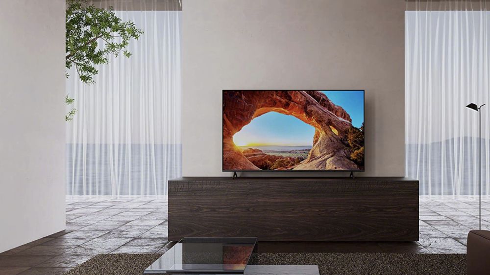 تلویزیون ۴۳ اینچی سامسونگ روی یک میز تلویزیون بزرگ در یک اتاق نشیمن رو به دریا