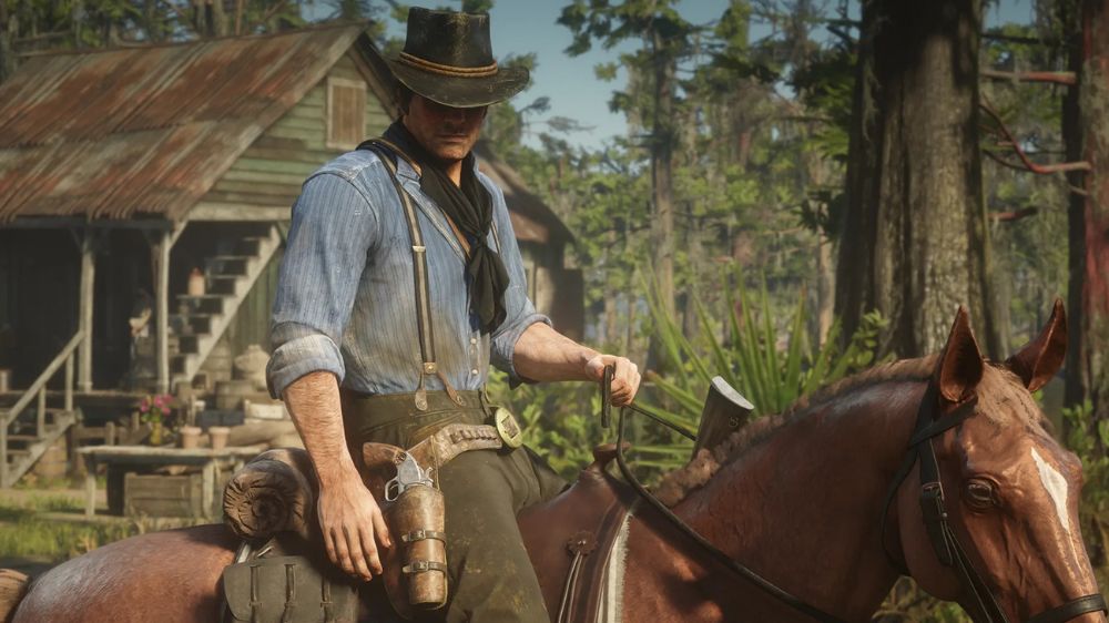 آرتور مورکان در حال اسب سواری با یک خانه اسب در پشت در بازی Red Dead Redemption 2